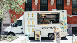white food truck parked on city street